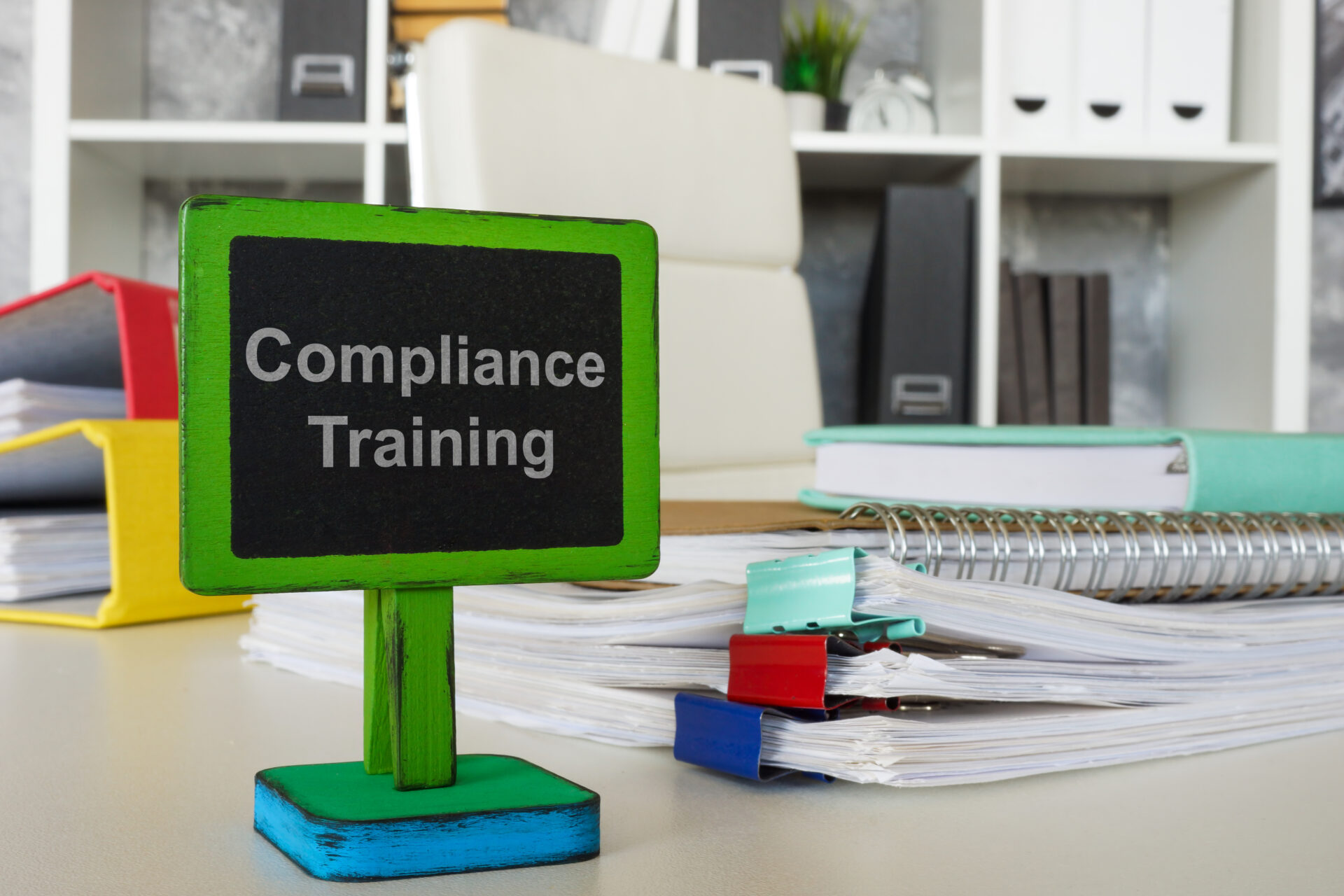 Compliance training sign on office desk.